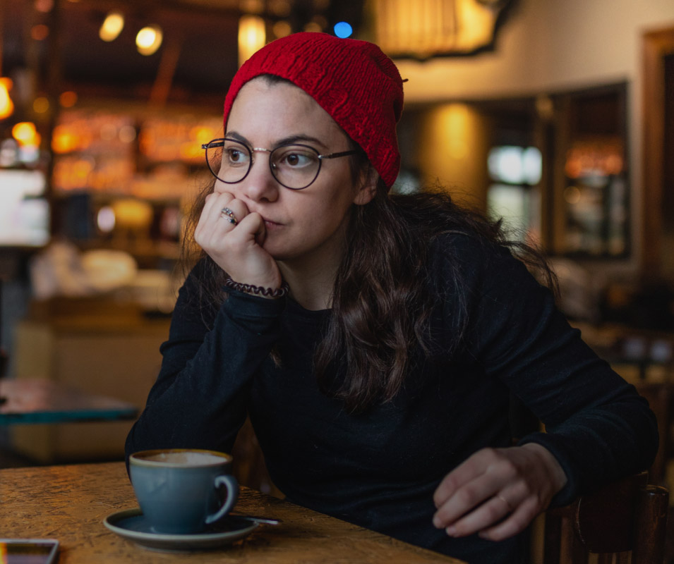 WOMAN AT A TABLE IN A CAFE