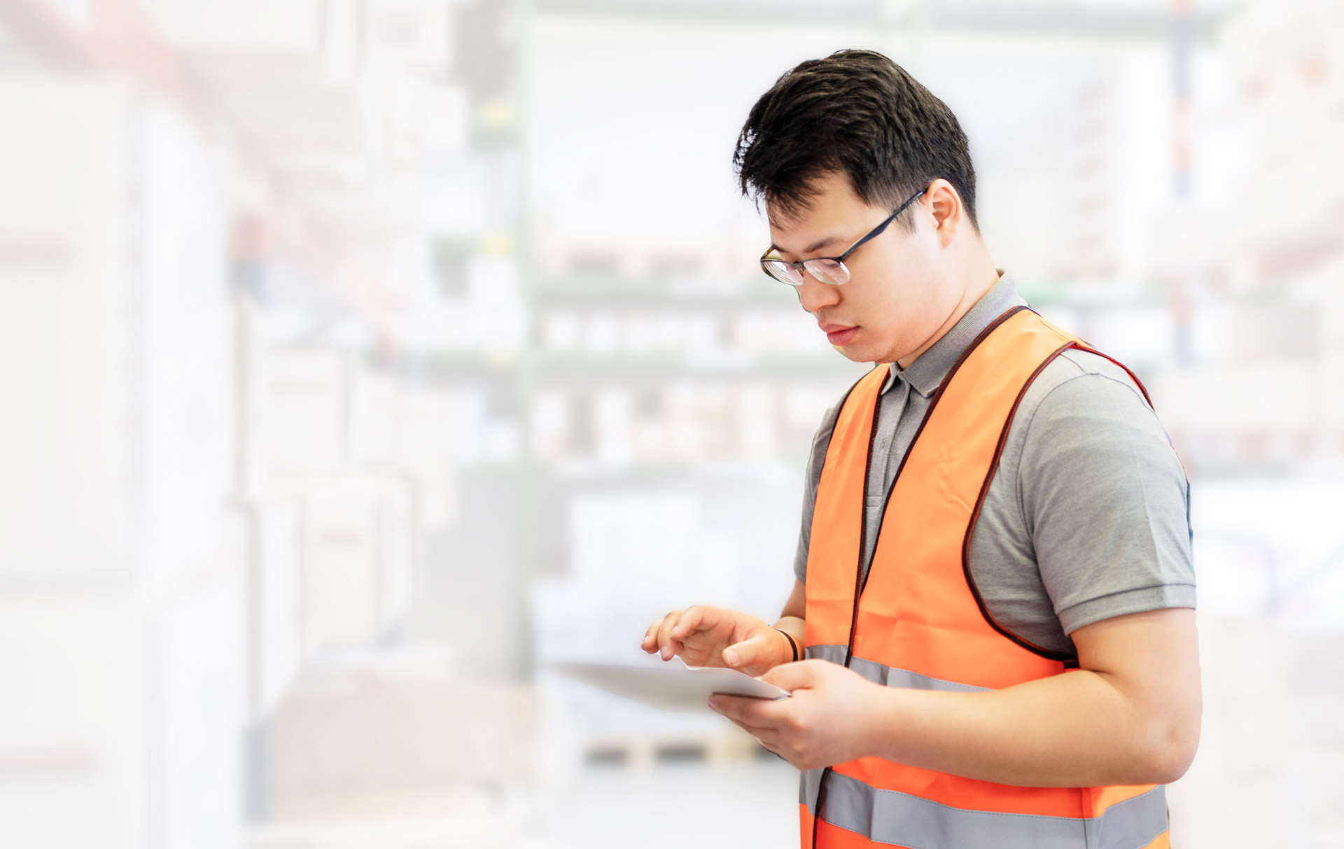 MAN AT WORK WEARING AN ORANGE VEST
