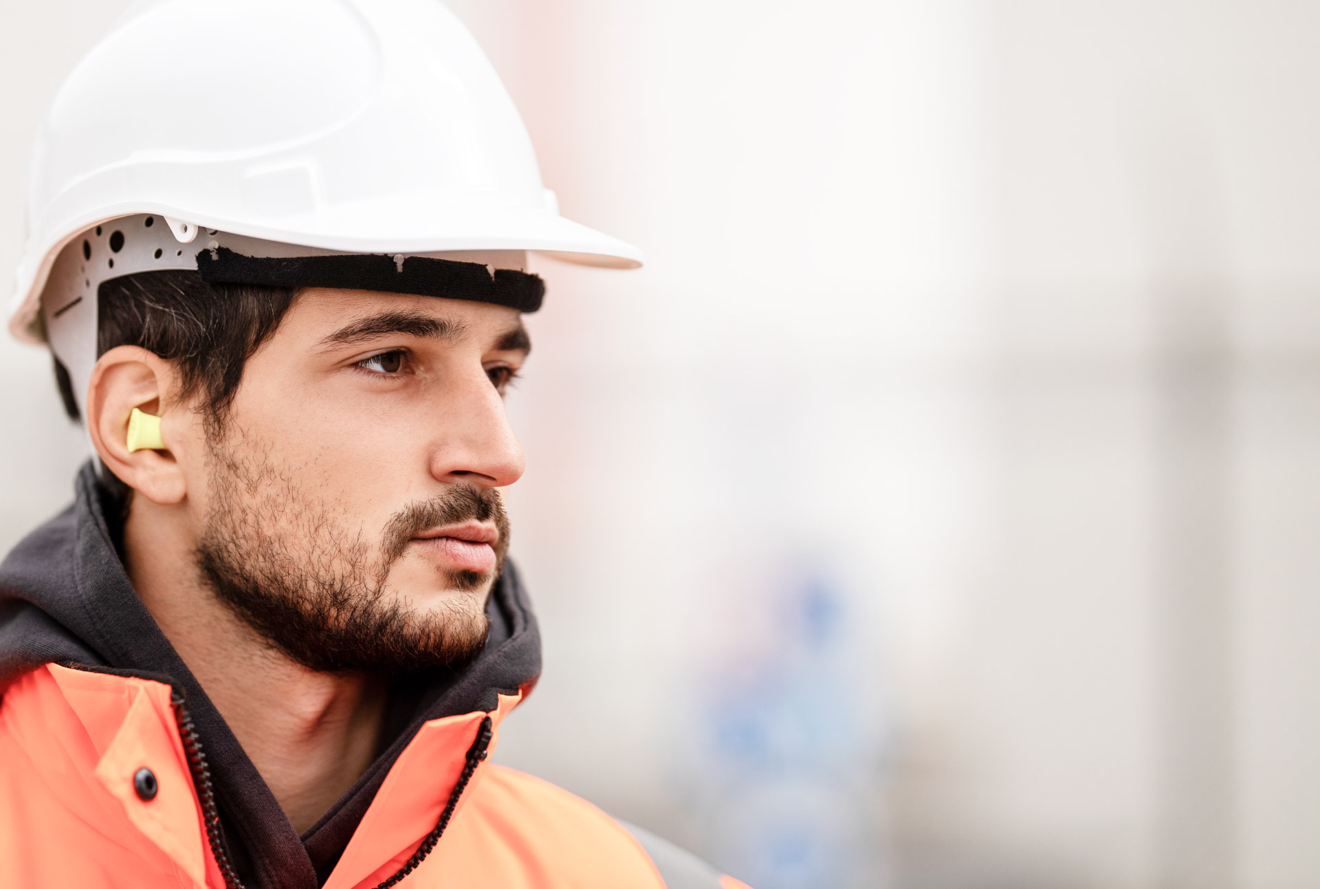 MAN IN CONSTRUCTION HAT AND ORANGE JACKET