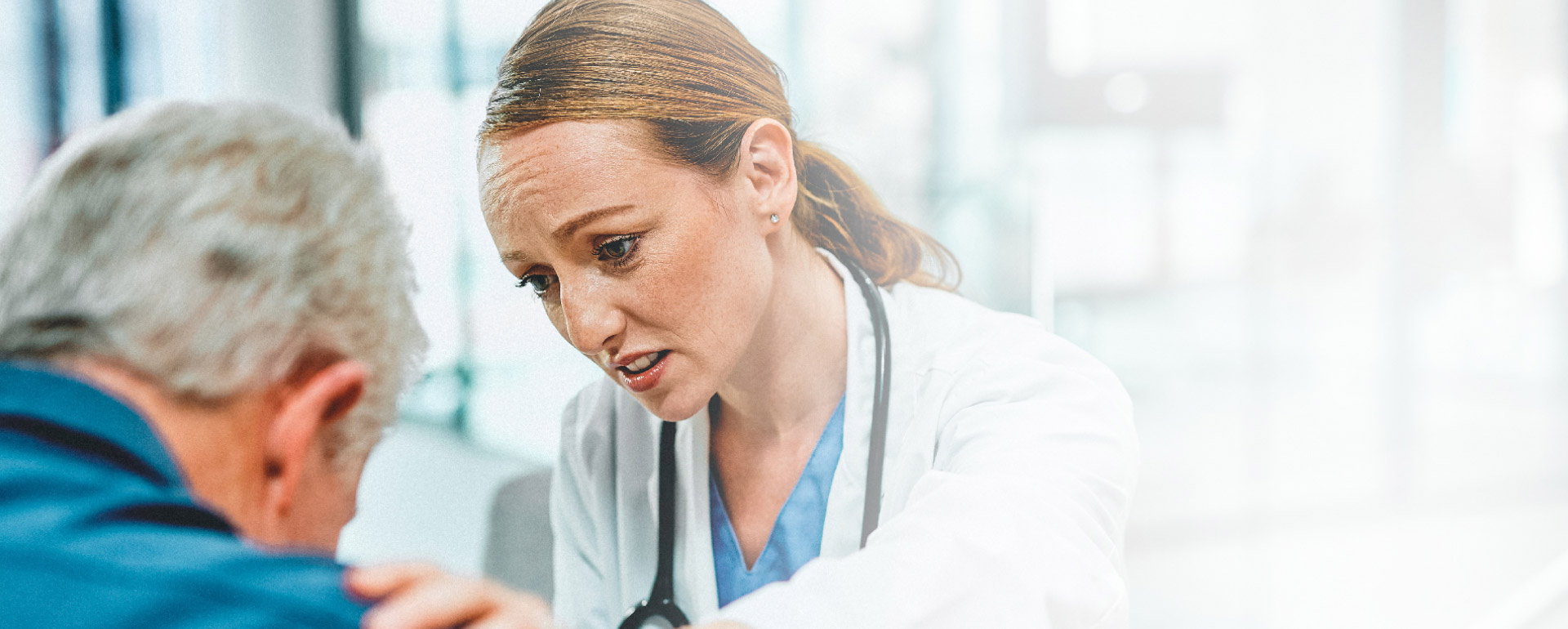 FEMALE DOCTOR COMFORTING PATIENT