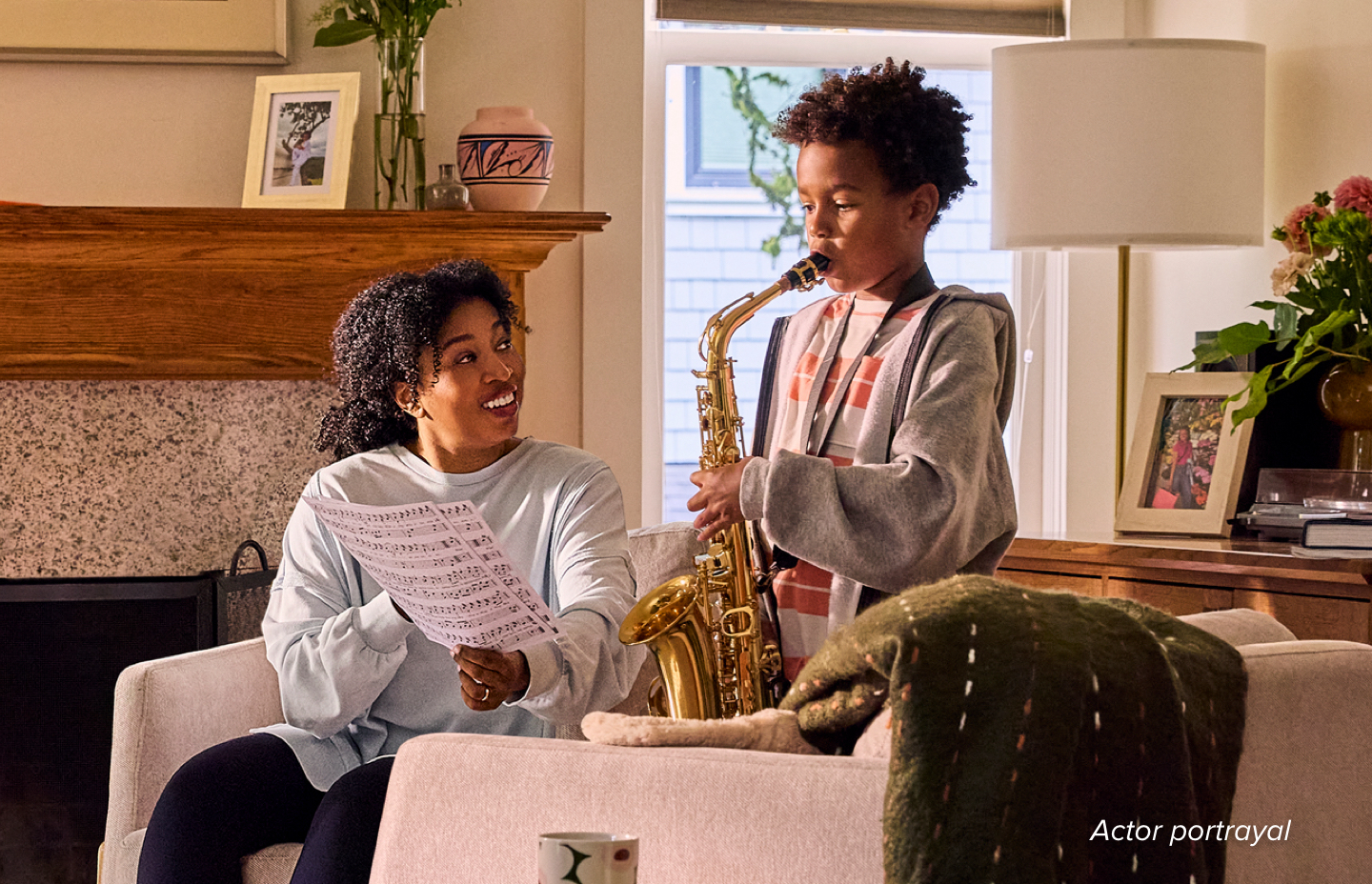 Female patient listening to her son play the saxophone.