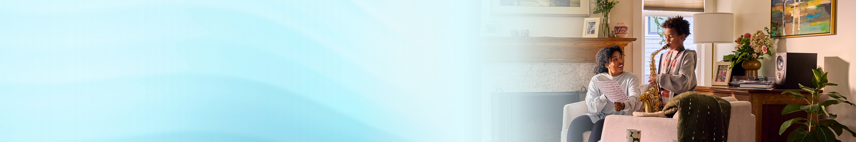 Female patient listening to her son play the saxophone.