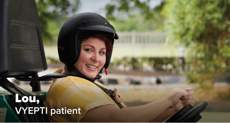 Lou, real VYEPTI patient, smiling in a go-cart